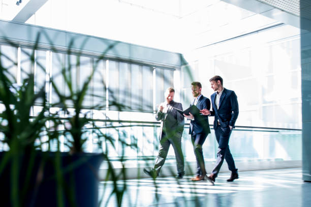 istock Businessmen walking in a hall 659324112