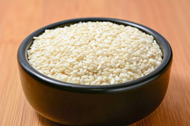 istock White sesame seeds in black bowl 659325640