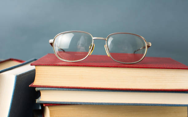 istock Reading glasses on top of book 659344546