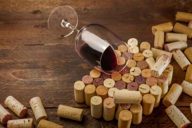 istock Glass of red wine and corks with place for text 659345148