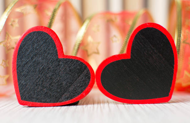 Two heart shapes in front of books