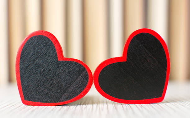 Two heart shapes in front of books