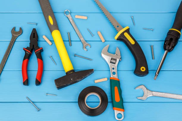 istock Straggly work tools laying on blue wooden background. 659386142