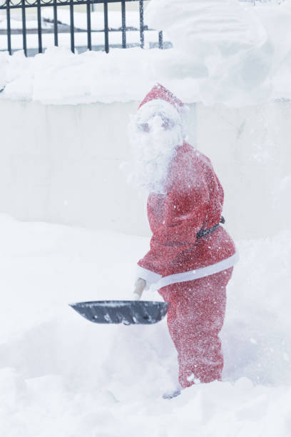 istock santa claus taking with shovel snow away 659395510