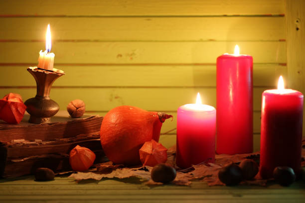 istock old book pumpkin and candle on wooden table 659425058