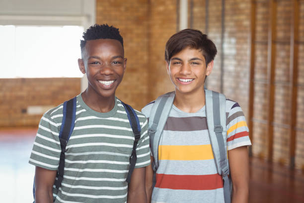 Portrait of happy schoolboys with schoolbag standing in campus Portrait of happy schoolboys with schoolbag standing in campus at school confident boy stock pictures, royalty-free photos & images