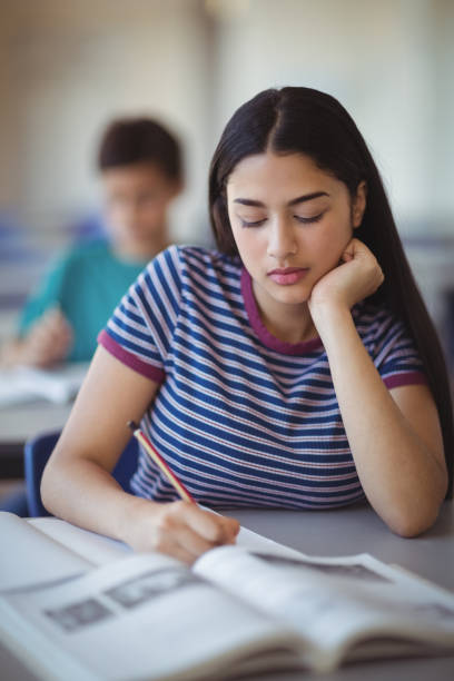 istock Attentive schoolgirl studying in classroom 659438844