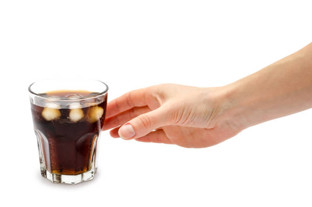 hand of girl holding glass of rum with coke. - woman reaching into handbag imagens e fotografias de stock