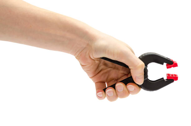 istock female hand holding clamp. 659449382
