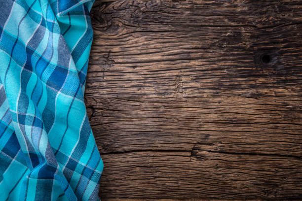 istock Top view of checkered tablecloth or napkin on empty wooden table 659450058