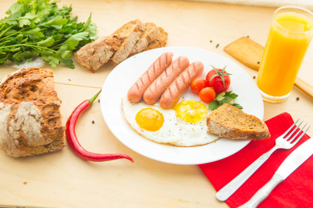 istock fried egg sausages tomatoes for healthy breakfast 659478640