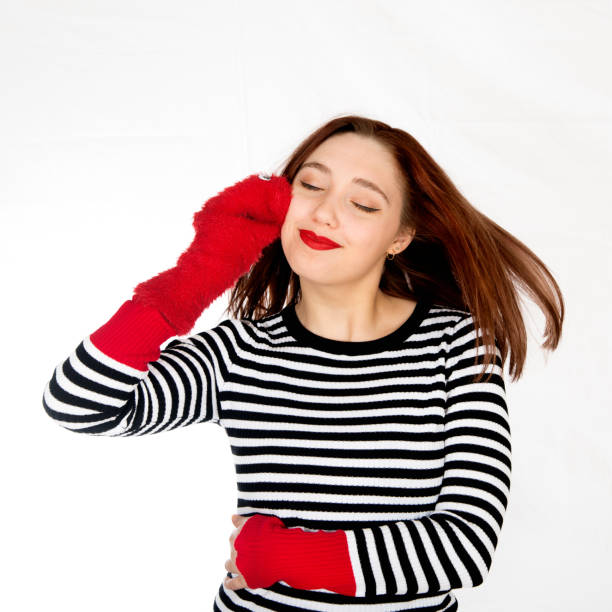 istock Expressive young woman cuddling with sock puppet, white background. 659500548