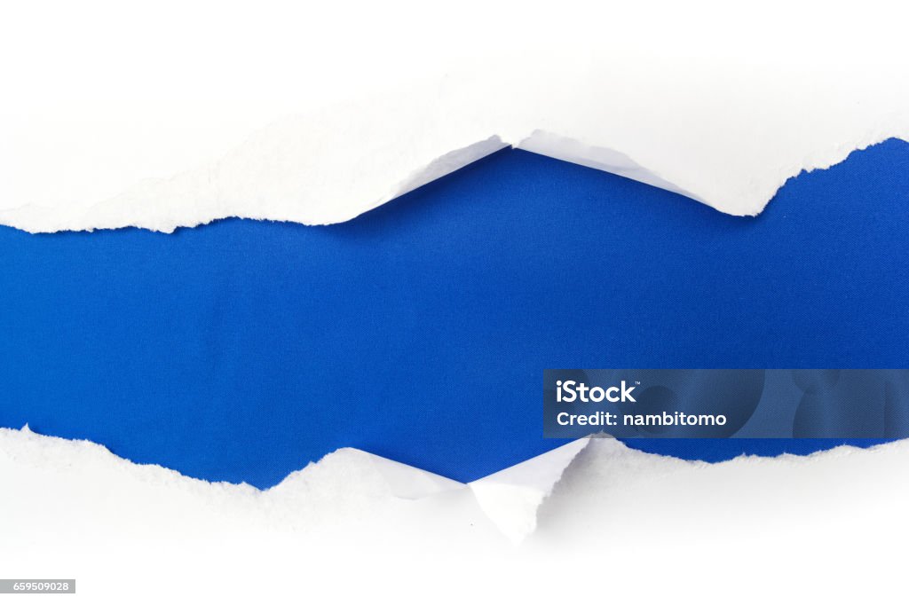 torn white paper on blue background. Cocept for autism awareness day. Break barriers together for autism torn white paper on blue background. Cocept for autism awareness day. Paper Stock Photo