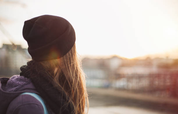Hipster girl looking at sunset stock photo