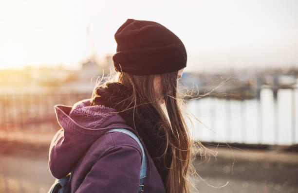 istock Girl walking on the bridge at sunset 659509308