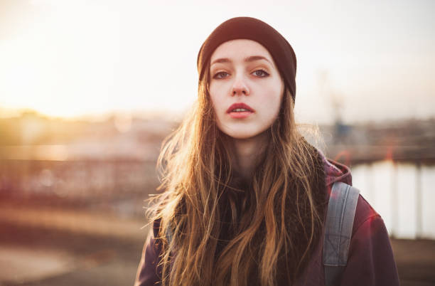 Portrait of a hipster girl at sunset stock photo