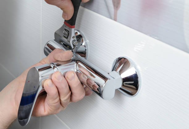 Installing a shower faucet. Man's hands fixing a shower faucet with a adjustable wrench. air valve photos stock pictures, royalty-free photos & images