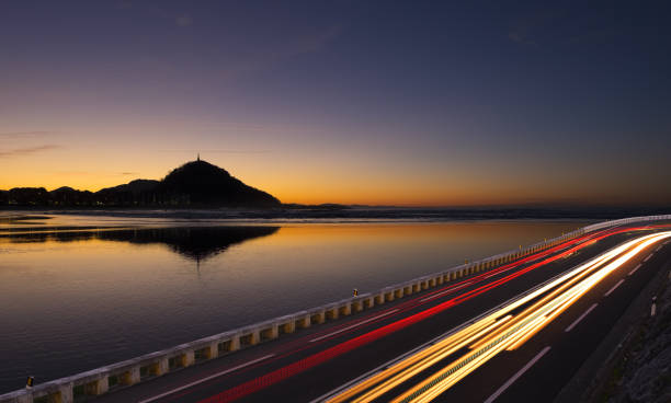 istock Moving car with blur light to city at night 659526238
