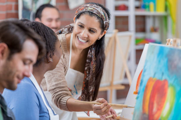 istock Confident artist teaches painting lesson 659542662