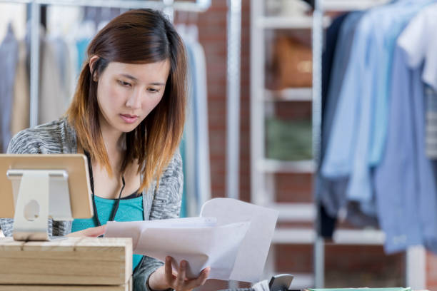 istock Busy clothing store clerk at work 659543206