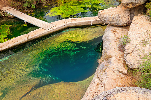 Stock photo of Jacob's Well, a karstic spring and waterhole in the Texas Hill Country flowing from the bed of Cypress Creek, located northwest of Wimberley, Texas, near Austin, Texas, USA.