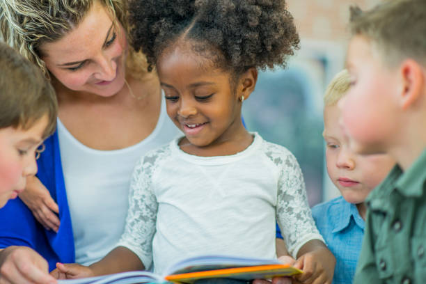 istock Young girl reading in group 659571400