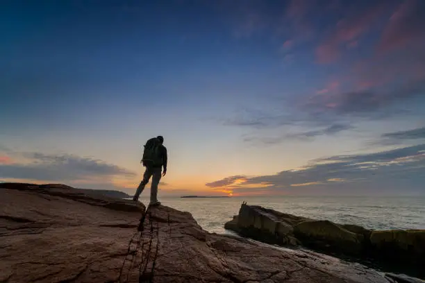 Photo of Backpacker watching the sunrise in Maine