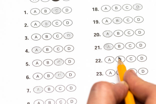 istock hand fill in Exam papers sheet and pencil 659585622