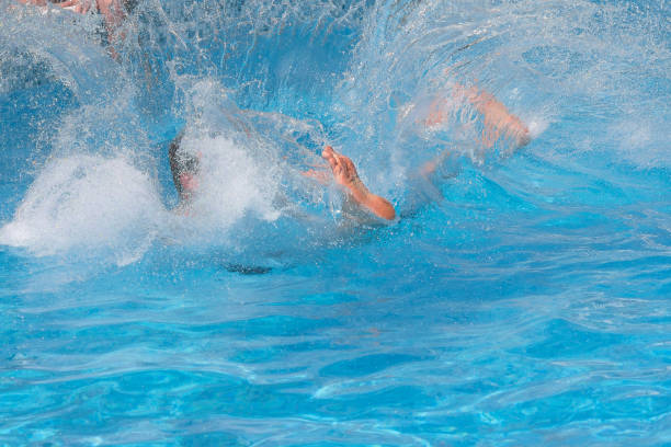 istock Man jumped into the pool making a lot of splashes 659603464