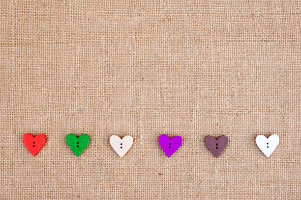 istock Background - burlap hessian with heart shape button decoration 659630712