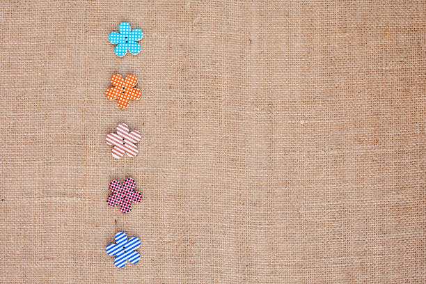 istock Background - burlap hessian with flower button decoration 659630806