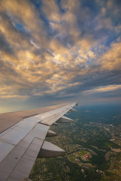 istock Airplane wing at sunset up in the sky 659635400