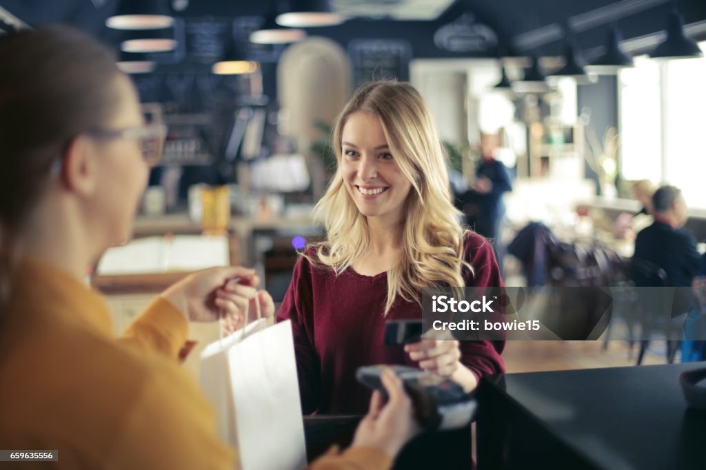 Paying with credit card Young woman is buying something Shopping Stock Photo