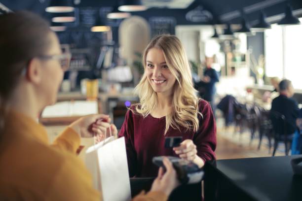 Paying with credit card Young woman is buying something hungary photos stock pictures, royalty-free photos & images