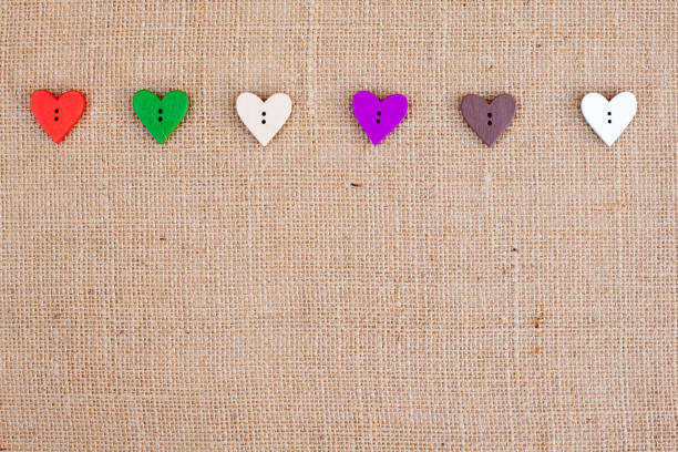 istock Background - burlap hessian with heart shape button decoration 659635878