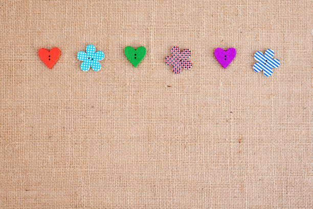 istock Background - burlap hessian with heart and flower button decoration 659638724