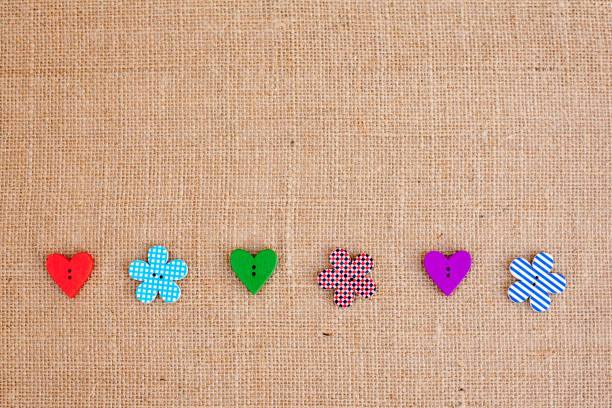 istock Background - burlap hessian with heart and flower button decoration 659640954