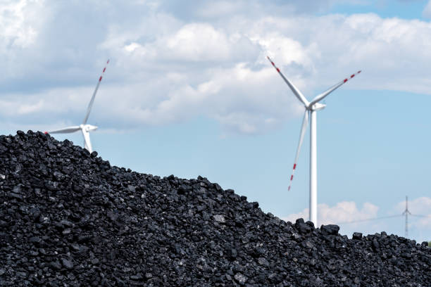 Pile of carbon and the windmill - fotografia de stock