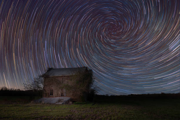 istock Abandoned home with a vortex spiral star trail 659653474
