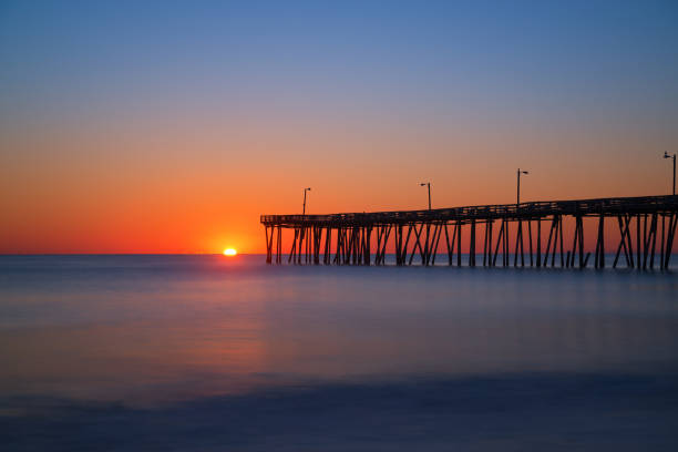 Long exposure of Nags Head Pier at sunrise Sunrise from Nags Head Pier in North Carolina. bodie island stock pictures, royalty-free photos & images