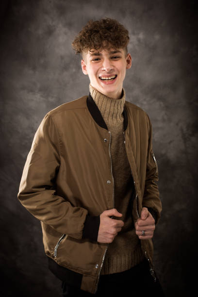 White Teenage Boy Studio Portrait One well dressed long haired male model teenager posing for yearbook senior picture high school photos stock pictures, royalty-free photos & images