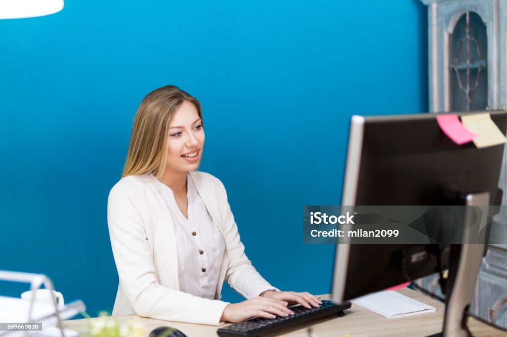 Using Her Computer In Her Office Stock Photo - Download Image Now ...