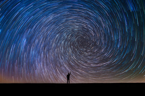 Pointing at the North Star in a star trail A silhouette of a man pointing to the polaris the north star! north star stock pictures, royalty-free photos & images