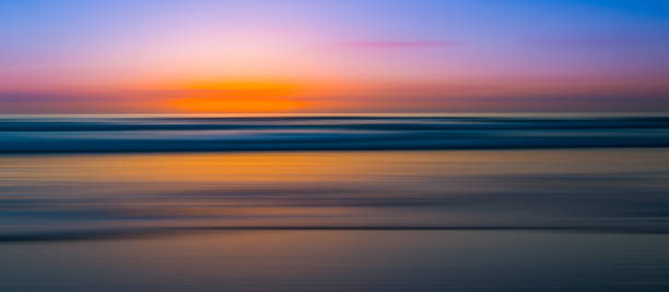 Abstract motion blur of a seascape panorama Colorful sunset at a beach with a motion blur to create an abstract image. la jolla stock pictures, royalty-free photos & images