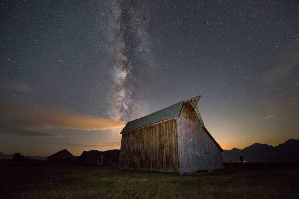 istock Milky Way Galaxy rising behind an old barn 659676936