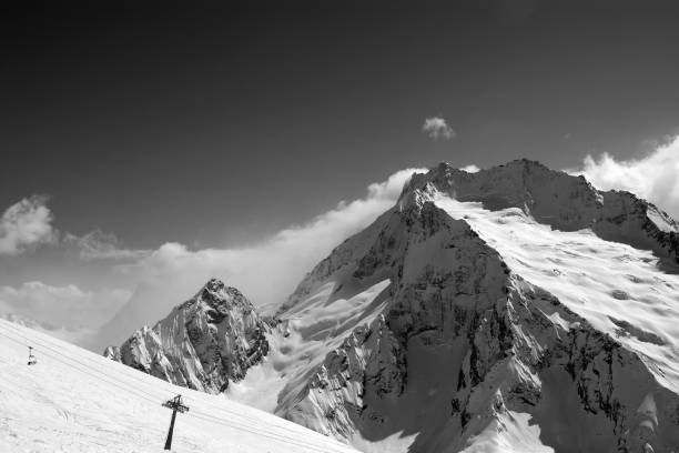 istock Black and white view on ski slope and snow mountain in winter 659677602