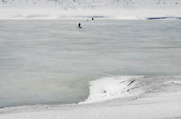 istock Features winter fishing.Cold winter evening on the river. 659678354