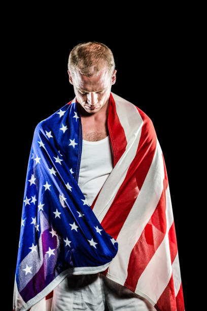 istock Athlete with american flag wrapped around his body 659684374