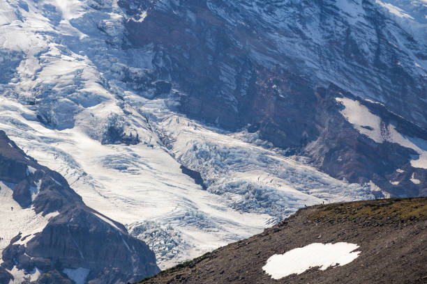 istock Close-up of Mount Rainier glaciers with two tiny people 659684988