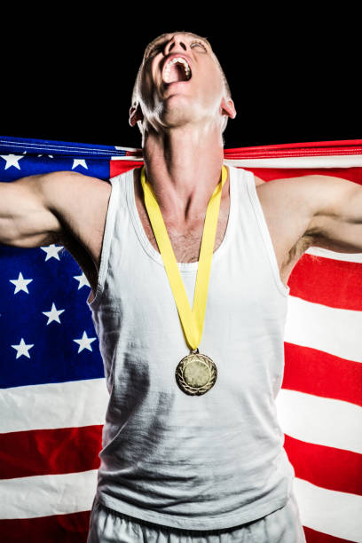 istock Athlete posing with gold medal after victory 659689632